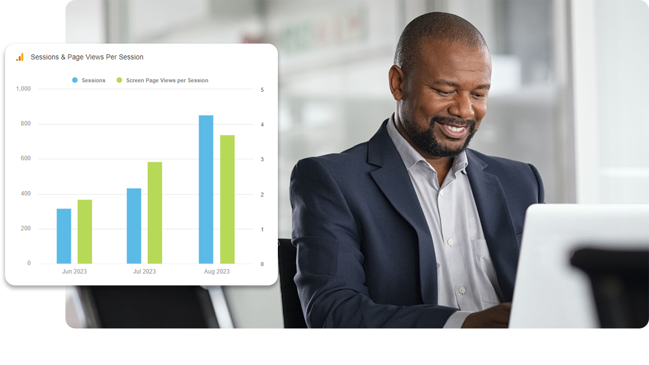man smiling while looking at his laptop