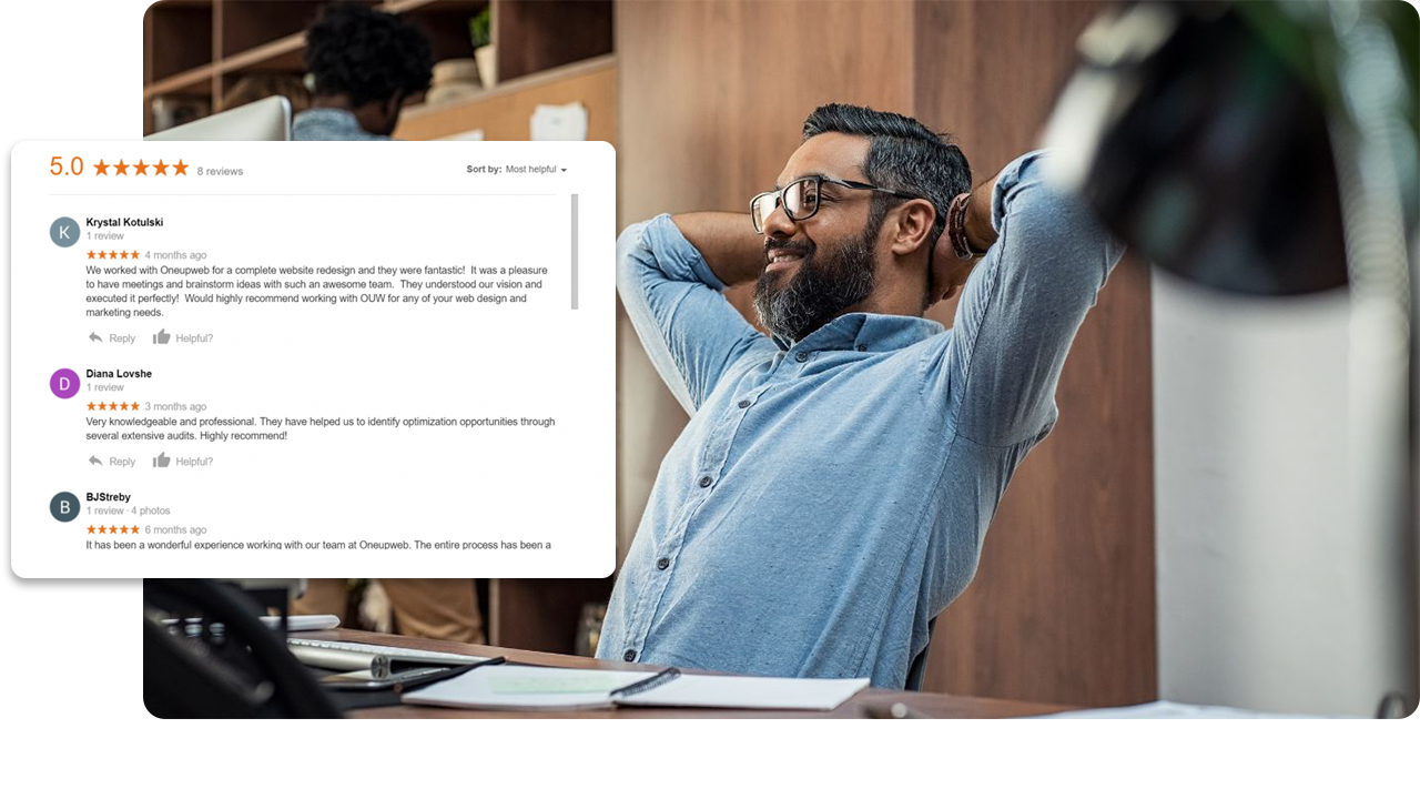 man smiling while staring at his desktop screen