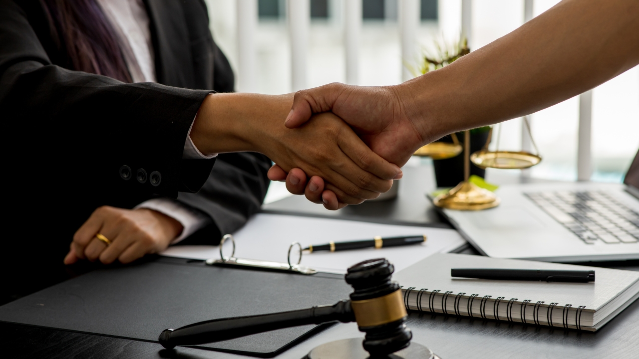 client shaking hands with lawyer
